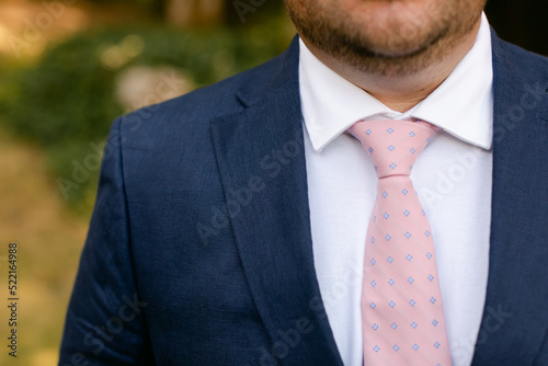 Closeup of Groom's Blue Suit and Pink Tie