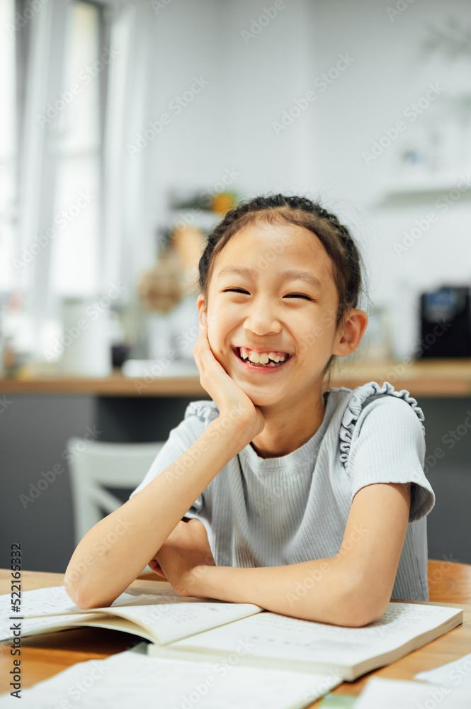Schoolgirl studying and smiling at cameras Schoolgirl studying and smiling at cameras