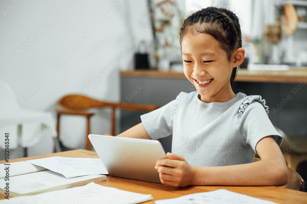Young girl home schooling with digital tablet Young girl home schooling with digital tablet