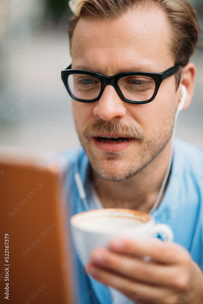 Man Drinking Coffee and Using Tablet Man Drinking Coffee and Using Tablet