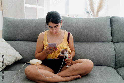 woman pumping breast milk photo