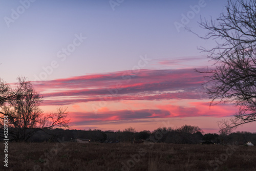 deep pink sunset sky over suburban rural landscape in Texas