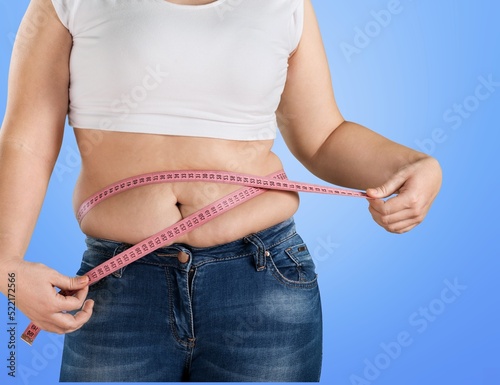 Young confused overweight plus size big fat fit woman hold measure tape. Workout sport concept