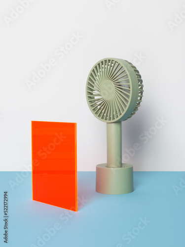 Still life with small fan and colored shape photo