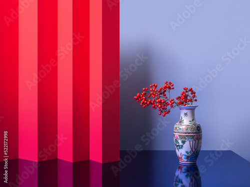 Asian vibes still life with red flowers in a Chinese vase