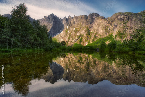 Fototapeta Naklejka Na Ścianę i Meble -  View of the beautiful reflection of the mountain called Troll Wall surrounded by mountains, in central Norway, near the famous Troll Ladder road