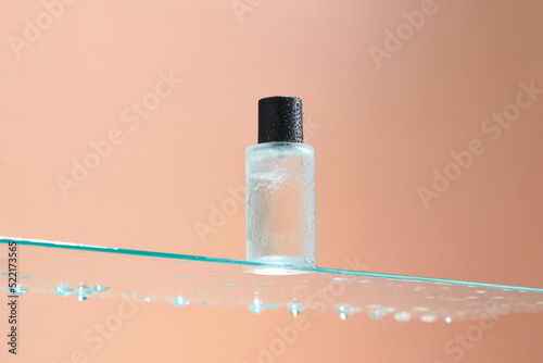 Bottom view of one bottle of toner stands on a glass table