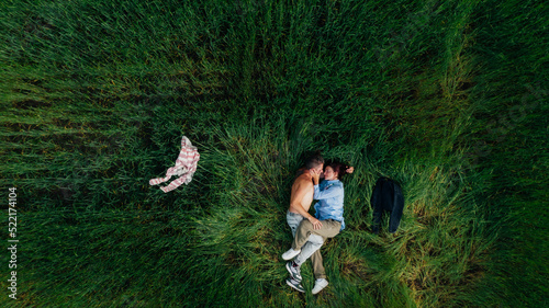 man and woman Laying On grass, hugging and kissing with clothes off