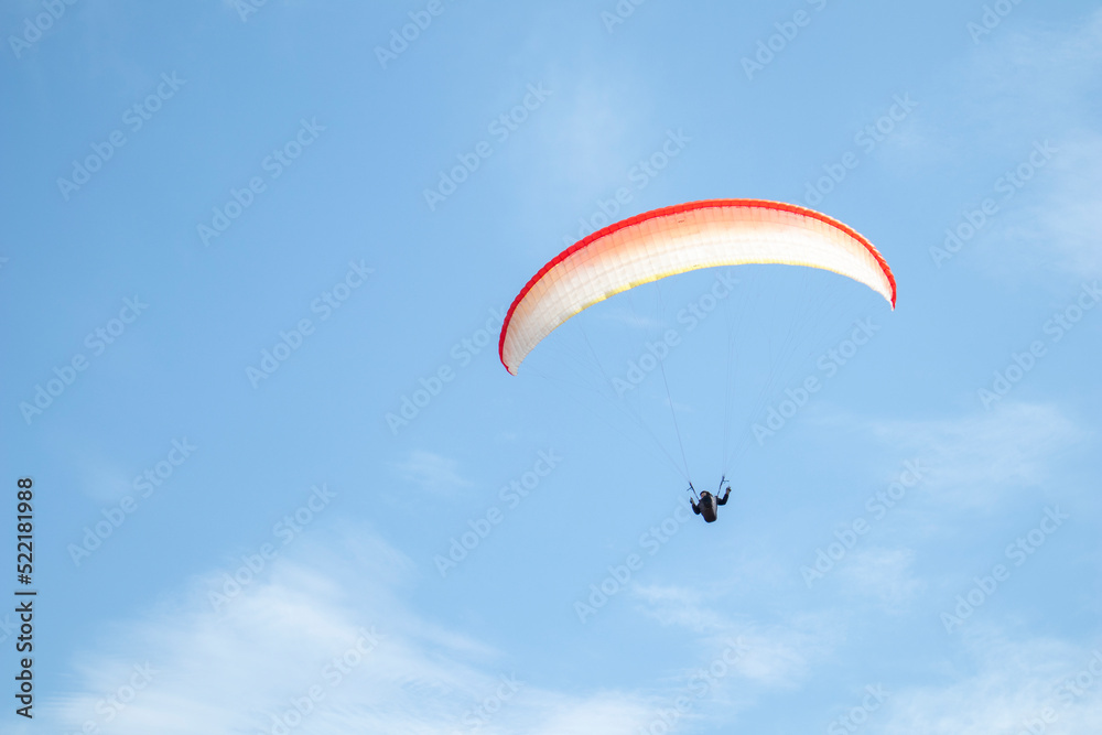 paragliding. extreme sport. a guy on a paraglider flies in the blue sky paragliding. extreme sport. a guy on a paraglider flies in the blue sky