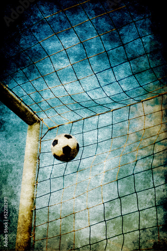 soccer post and ball into the net , with a gritty effect © Visualmind