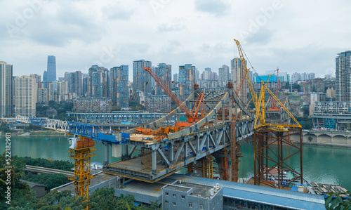 Photography This is Chongqing, China, where a bridge is being built over a large river