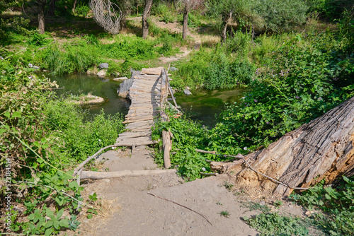 old wooden bridge over small river, wood path, a beautiful summer landscape