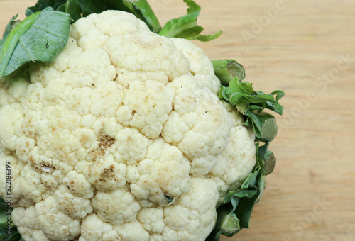close-up photo of cauliflower on a wooden cutting board