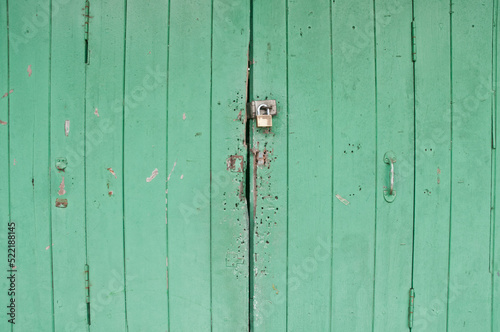 Dark bright lemonade lime green wooden old door with a metalic h © eyeofpaul