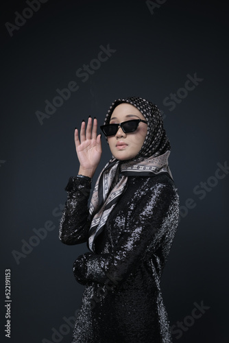 Portrait of a female  wearing a hijab, a form of lifestyle garments for Muslim women, isolated on a background. Eid festive and hijab fashion concept
