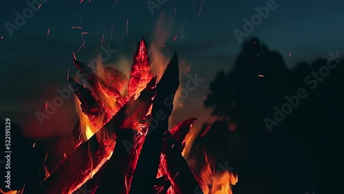 Big Burning Campfire at Summer Night against the Blue Sky. Wood on Fire. Flying Sparks. Travel and Tourism Concept. Giant Flaming Bonfire - Static Shot, Slow Motion