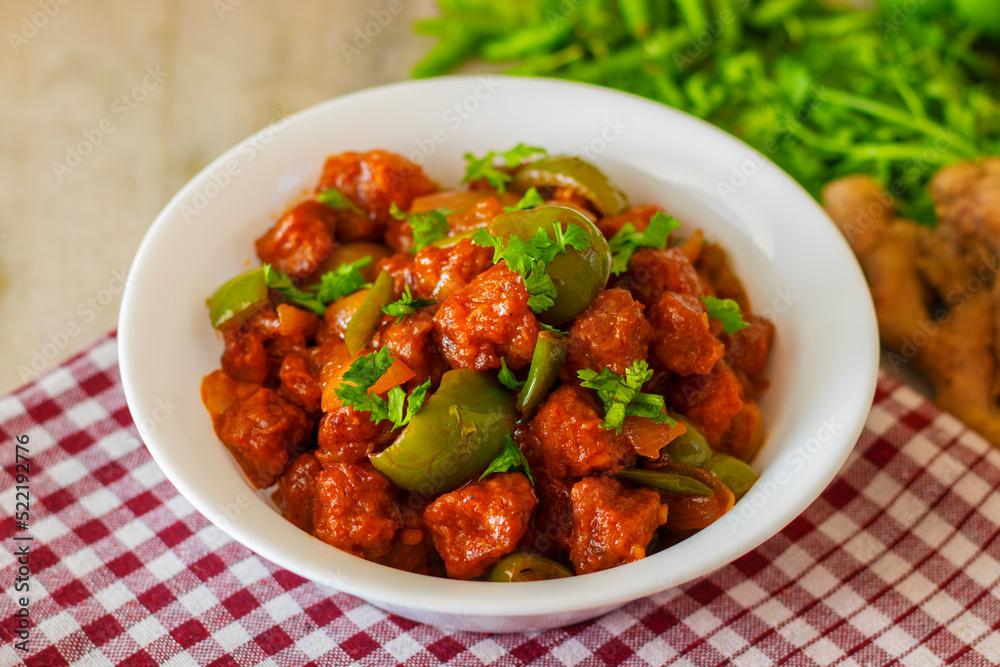 selective focus of Soya Manchurian/Chili Soya bean chunks recipe. with a decorative background.