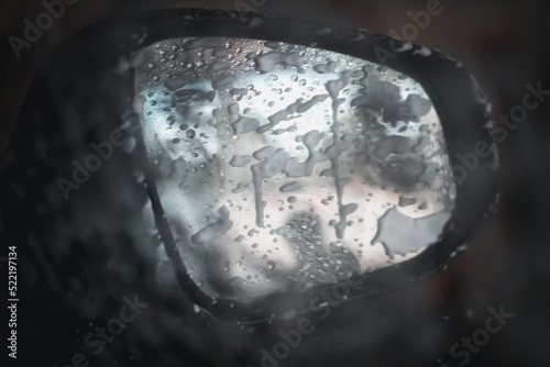 Close up of car mirror during the wash