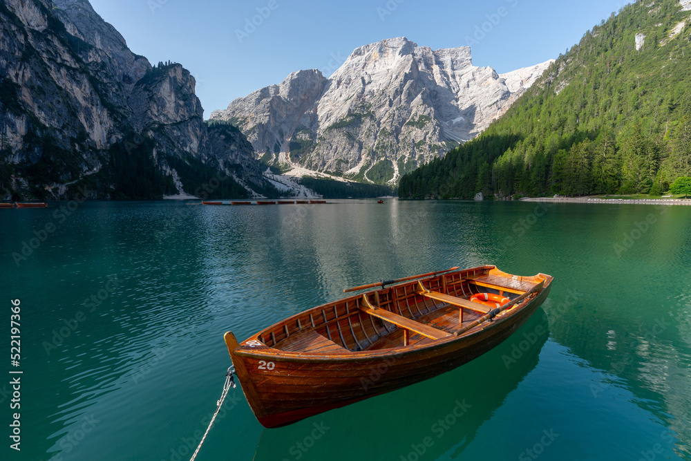 Amazing Sunrise view of Lago di Braies (Pragser Wildsee) with Wooden boats, one of the most beautiful lake in South Tirol, Dolomites mountains, Italy. Popular tourist attraction.