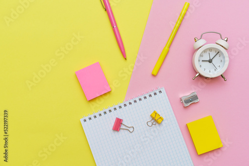 School supplies, stationery on pink background. Pens pencils notepad. Flat lay, top view. Back to school concept