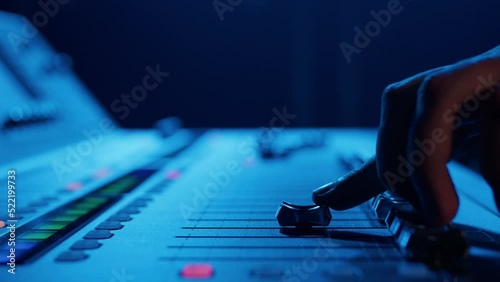 Close-up of the hands of a male DJ who controls the sound on a professional controller