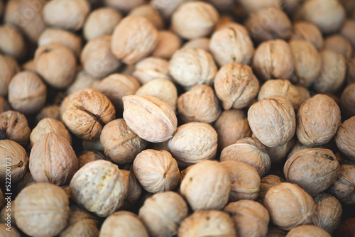 Heap of whole walnuts - full frame natural pattern background detail.