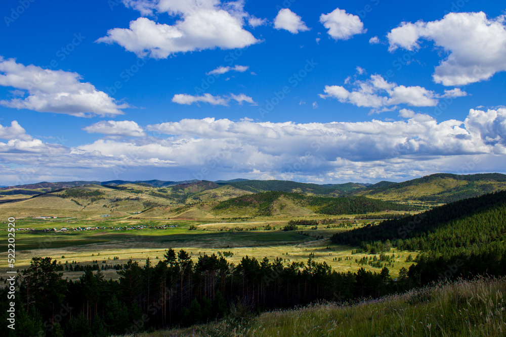 Scenic view of mountains, forests and valleys from mountain peak Scenic view of mountains, forests and valleys from mountain peak