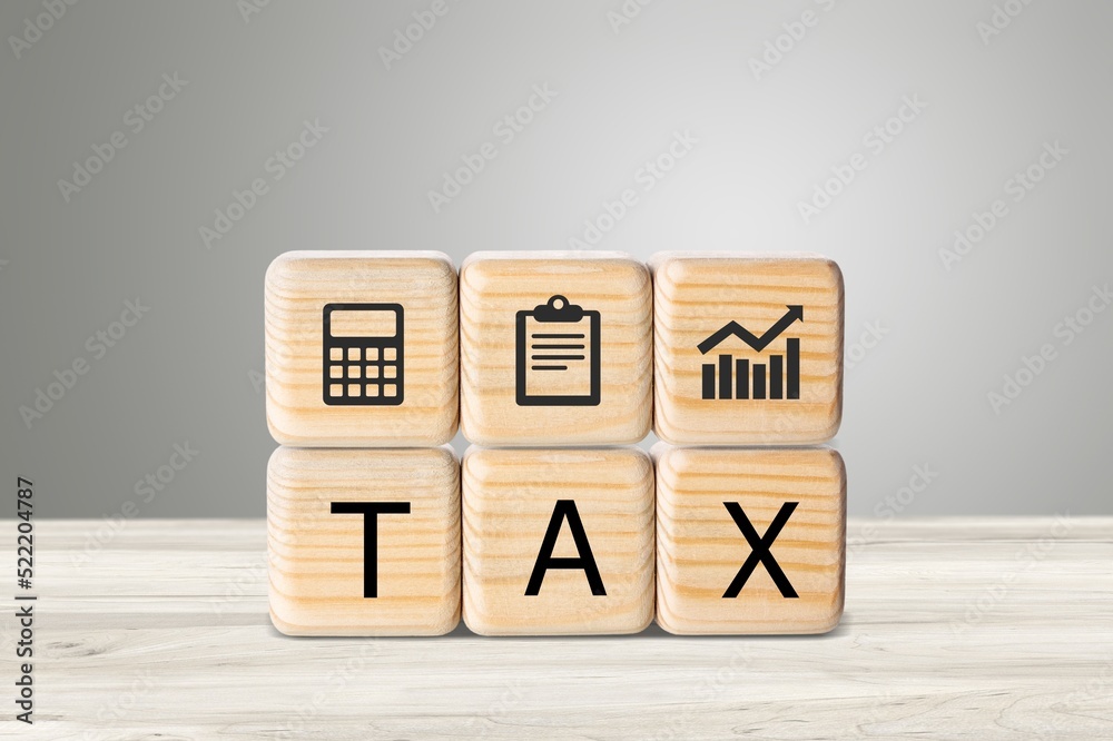 TAX concept, on wooden block on the desk TAX concept, on wooden block on the desk