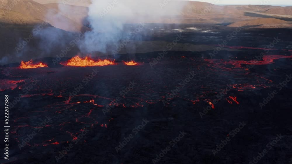 Incredible active lava field with fissure volcano in remote nordic valley, aerial Incredible active lava field with fissure volcano in remote nordic valley, aerial