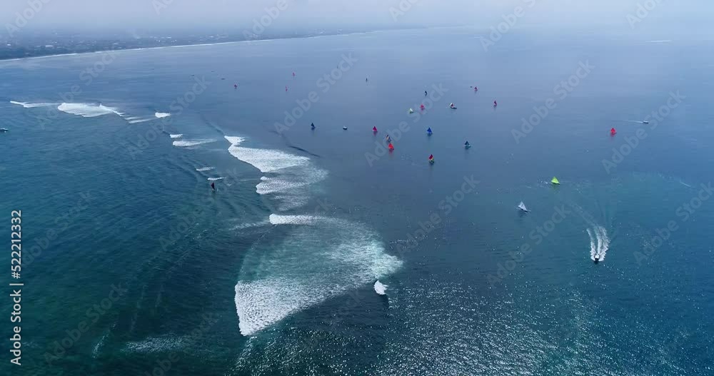 Aerial shot of many traditional indonesian boats going over shallow water