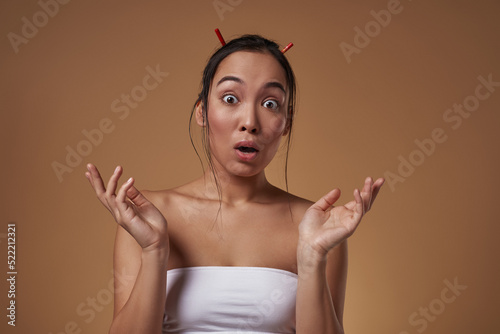 Shocked asian girl with open mouth look at camera
