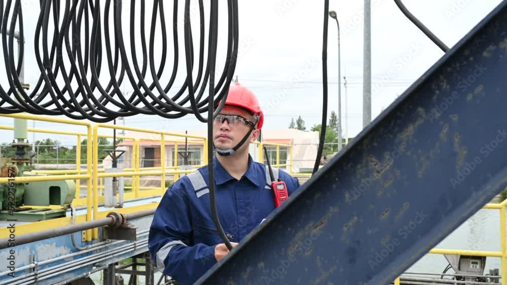 Water plant maintenance technicians, mechanical engineers check the control system at the water treatment plant. Water plant maintenance technicians, mechanical engineers check the control system at the water treatment plant.