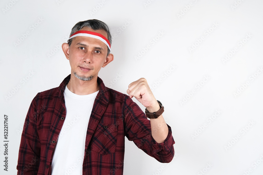 Portrait of Asian Man wearing red and white Indonesia flag attribute. Independence day concept.
Portrait of Asian Man wearing red and white Indonesia flag attribute. Independence day concept.
