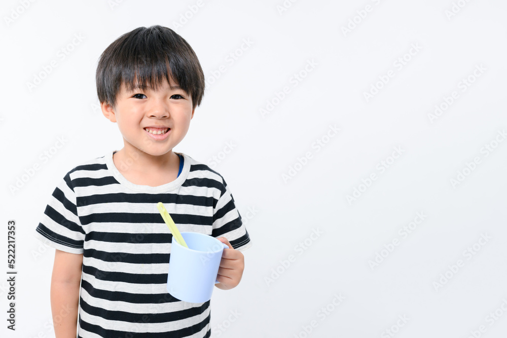 Child brushing teeth, front view, looking at camera Child brushing teeth, front view, looking at camera