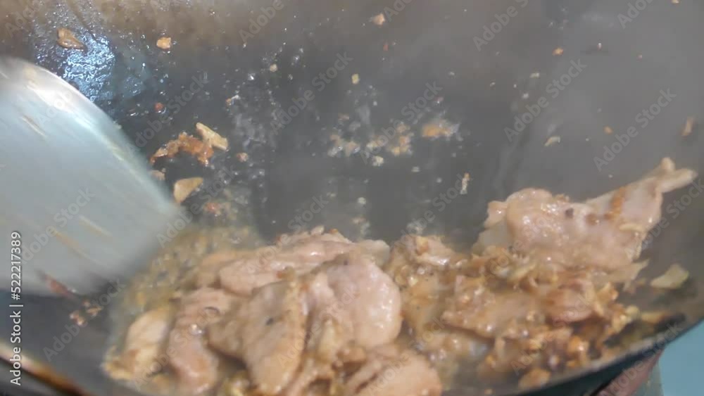Cooking Stir Fried Garlic And Pepper Pork In Wok With Smoke of Aroma Float On It, Close Up, Slow-Motion Cooking Stir Fried Garlic And Pepper Pork In Wok With Smoke of Aroma Float On It, Close Up, Slow-Motion
