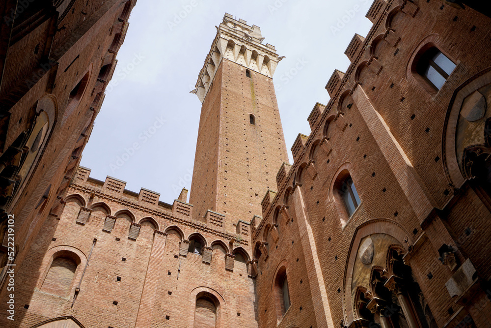 Siena City Hall. View from Palazzo Pubblico courtyard with the imposing tower Torre del Mangia, Siena, Tuscany, Italy.