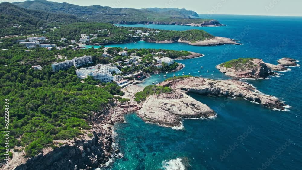 Luxury villas, mansions, apartments and hotels in Portinatx, Ibiza, Spain. Scenic view of modern buildings and resorts in the middle of the nature of the Balearic Islands on a summer day. Luxury villas, mansions, apartments and hotels in Portinatx, Ibiza, Spain. Scenic view of modern buildings and resorts in the middle of the nature of the Balearic Islands on a summer day.