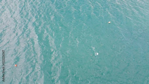 Zooming out aerial view of Castiglioncello coast side near famous Bagni Graziella. Aerial flying over water area cliff rock beaches. Sunny day, mid July summer. Tuscany Livorno Italy photo