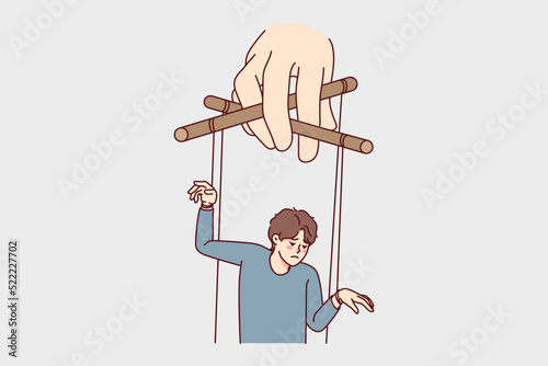 Hand holding man on ropes manipulating steps and actions. Puppeteer control unhappy guy. Manipulation and lack of freedom. Vector illustration. 
