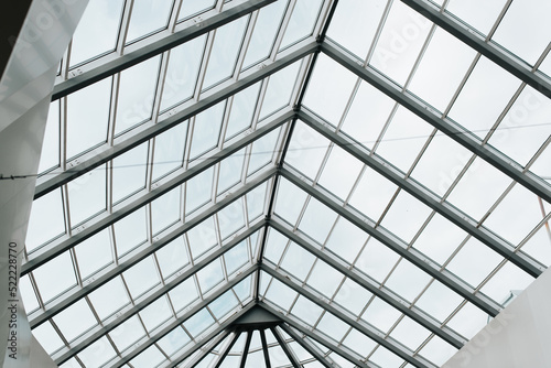 Glass roof construction with metal structure indoors