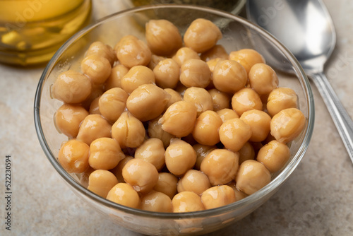 Glass bowl with preserved steamed chickpeas close up  