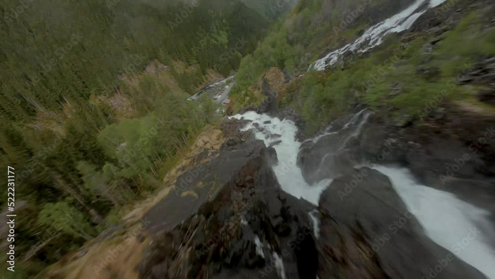 Aerial drone flight downhill Låtefoss Waterfall into valley in Norway Aerial drone flight downhill Låtefoss Waterfall into valley in Norway