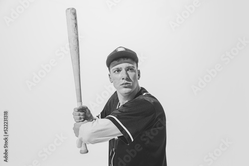 Photography Black and white portrait of concentrated young man, baseball player in uniform w