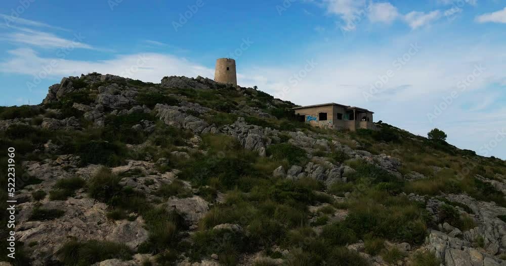 Watchtower in Mallorca slow pedestal up dramatic aerial reveal. Atalaya de Albercutx Watchtower in Mallorca slow pedestal up dramatic aerial reveal. Atalaya de Albercutx
