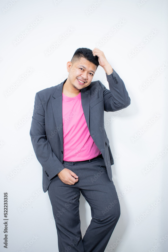 © Igunt - Modelling snapshots. Serious narcissistic self-confident attractive handsome man in classic suit holds hands on belt posing isolated in white studio background. Fashion offer. Copy space for ad