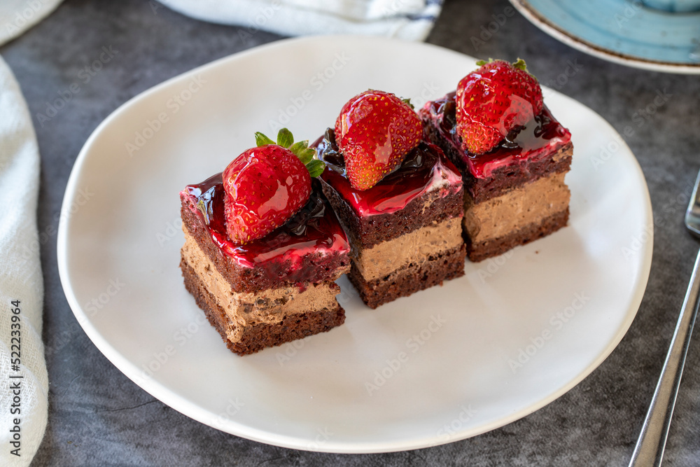 Strawberry tartlet. Small strawberry cake in a plate. On dark floor. close up Strawberry tartlet. Small strawberry cake in a plate. On dark floor. close up
