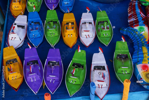 A collection of traditional boat toys in a toy merchant at PKB, Bali. This toy is an old toy that many children played in the 80-90s. photo