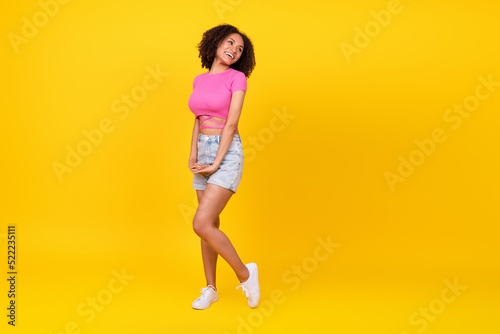 Fototapeta Naklejka Na Ścianę i Meble -  Full size photo of cute brunette young lady look promo wear top shorts boots isolated on orange color background