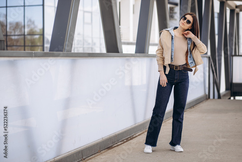 Young woman in casual wear posing in the street