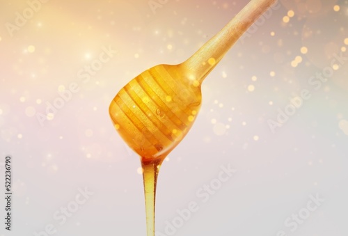 Golden honey flows from the stick. Aromatic nectar